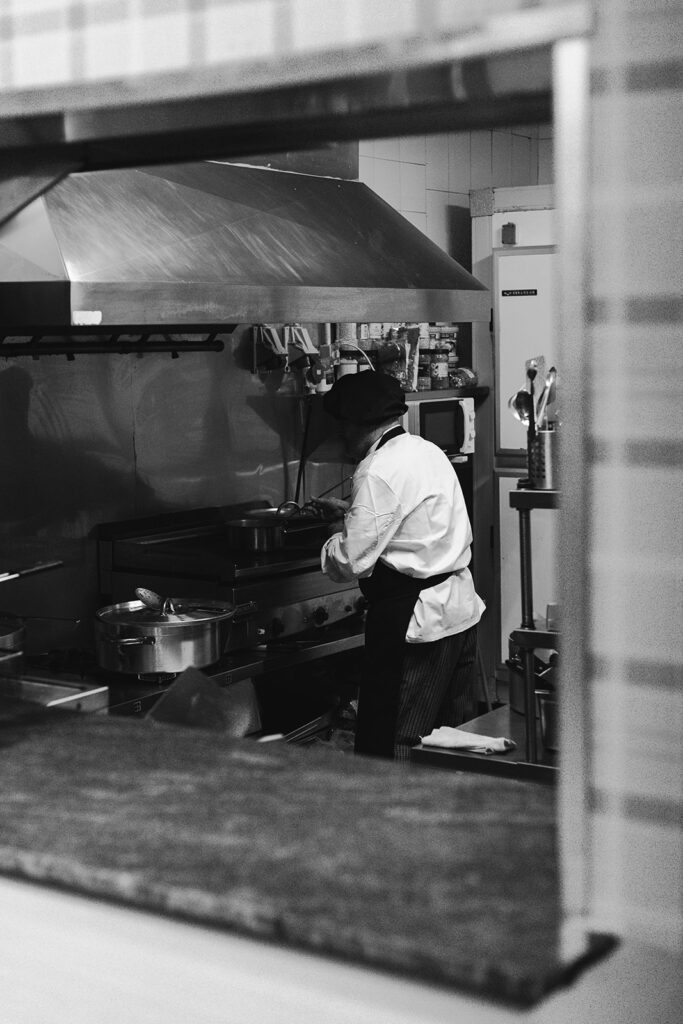 Restaurante La Chata vista cocina y cocinero en blanco y negro